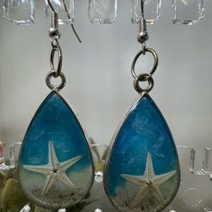 Handmade, beach inspired, real sand in resin. Hooks are 925 silver plated.
